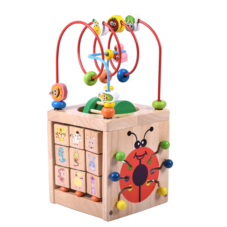 Wooden children's puzzle beetle surrounded by large beads